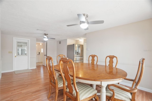 12106 Bear Creek Ln, Hudson, FL 34667 - dining room featuring a ceiling fan, baseboards, and light wood finished floors
