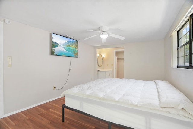 12106 Bear Creek Ln, Hudson, FL 34667 - bedroom featuring wood finished floors, baseboards, a ceiling fan, and connected bathroom