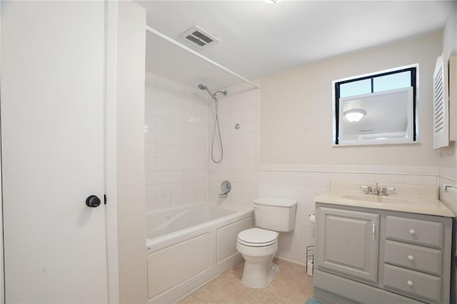 12106 Bear Creek Ln, Hudson, FL 34667 - full bath with toilet, tile patterned flooring, vanity, bathing tub / shower combination, and tile walls