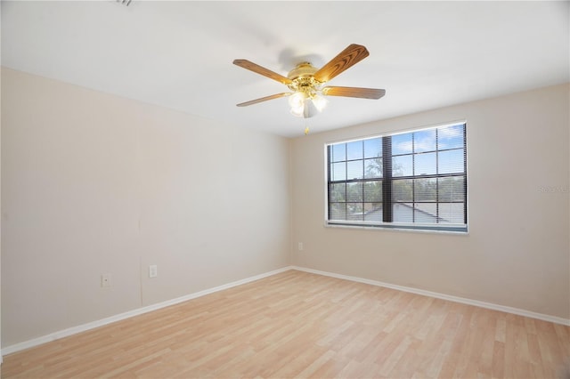 12106 Bear Creek Ln, Hudson, FL 34667 - empty room featuring light wood finished floors, ceiling fan, and baseboards