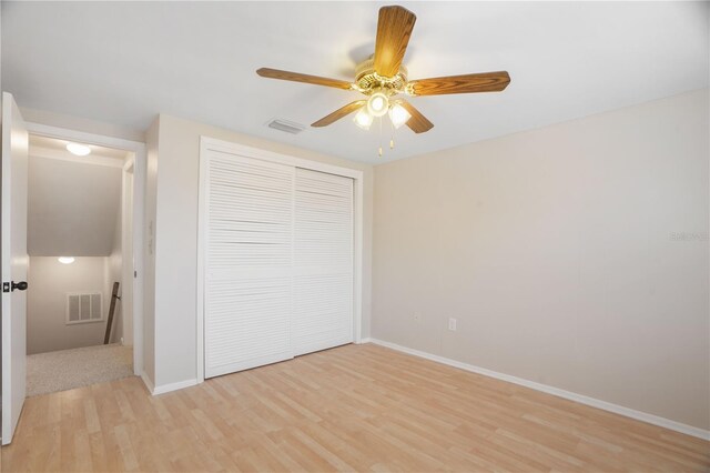 12106 Bear Creek Ln, Hudson, FL 34667 - unfurnished bedroom with light wood-style floors, a closet, baseboards, and a ceiling fan