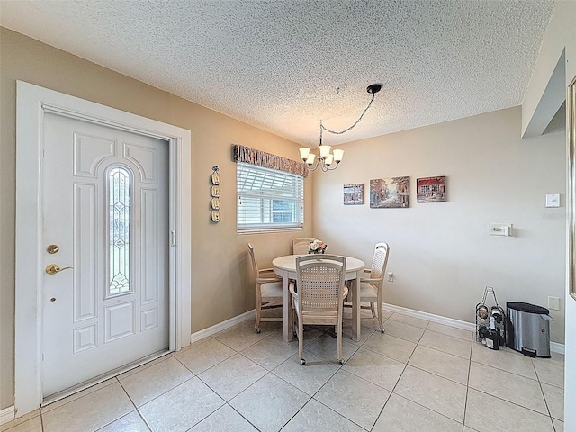 11821 Boynton Ln, New Port Richey, FL 34654 - dining space featuring a chandelier, a textured ceiling, light tile patterned flooring, and baseboards