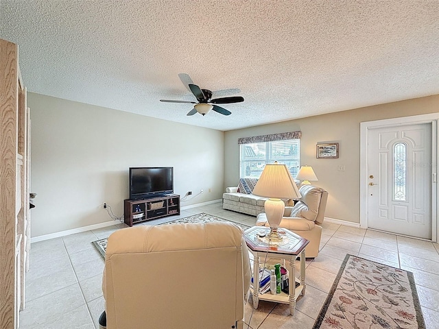 11821 Boynton Ln, New Port Richey, FL 34654 - living area featuring light tile patterned flooring, a ceiling fan, baseboards, and a textured ceiling