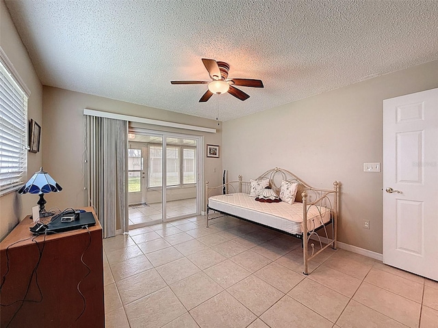 11821 Boynton Ln, New Port Richey, FL 34654 - bedroom featuring light tile patterned floors, access to exterior, multiple windows, a textured ceiling, and a ceiling fan