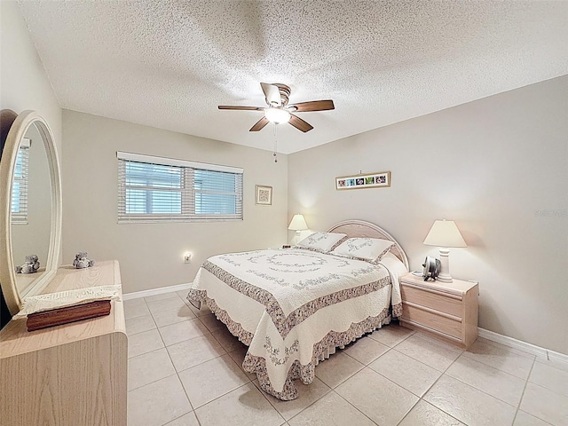 11821 Boynton Ln, New Port Richey, FL 34654 - bedroom with light tile patterned floors, baseboards, ceiling fan, and a textured ceiling