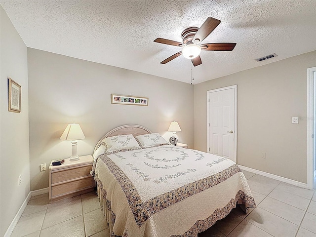 11821 Boynton Ln, New Port Richey, FL 34654 - bedroom with light tile patterned floors, baseboards, a textured ceiling, and ceiling fan