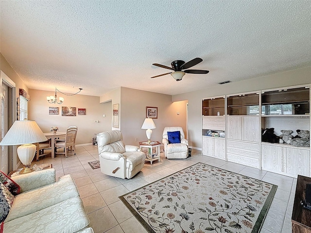 11821 Boynton Ln, New Port Richey, FL 34654 - tiled living room featuring a chandelier, a ceiling fan, and a textured ceiling