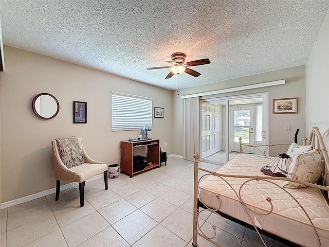 11821 Boynton Ln, New Port Richey, FL 34654 - bedroom with access to outside, light tile patterned floors, a textured ceiling, a ceiling fan, and baseboards