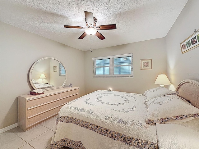 11821 Boynton Ln, New Port Richey, FL 34654 - bedroom with light tile patterned flooring, a ceiling fan, baseboards, and a textured ceiling