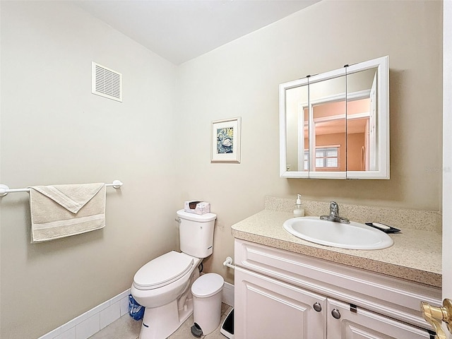 11821 Boynton Ln, New Port Richey, FL 34654 - half bath featuring vanity, toilet, baseboards, and tile patterned floors