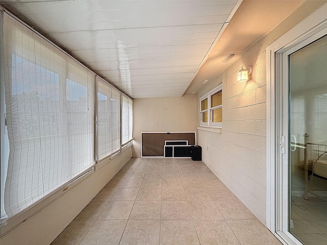 11821 Boynton Ln, New Port Richey, FL 34654 - unfurnished sunroom with plenty of natural light and tile patterned floors