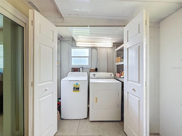 11821 Boynton Ln, New Port Richey, FL 34654 - washroom with washing machine and dryer and light tile patterned floors