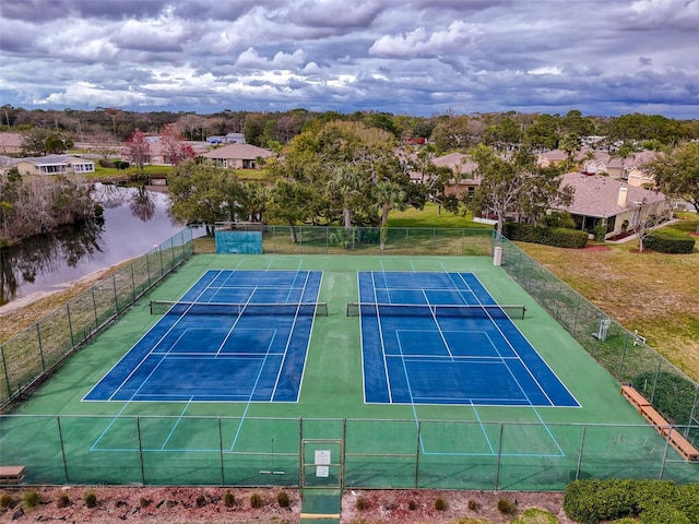 11821 Boynton Ln, New Port Richey, FL 34654 - view of tennis court featuring a water view and a residential view