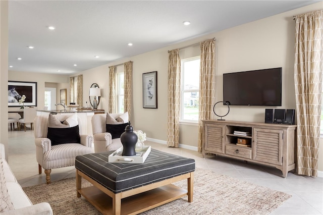 living area featuring light tile patterned floors, recessed lighting, and baseboards