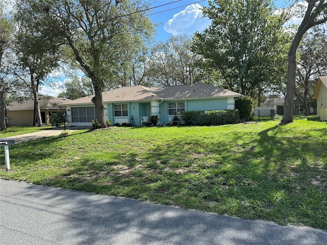 2158 Clayton Ave, Spring Hill, FL 34609 - ranch-style home featuring concrete driveway, a front lawn, a garage, and stucco siding