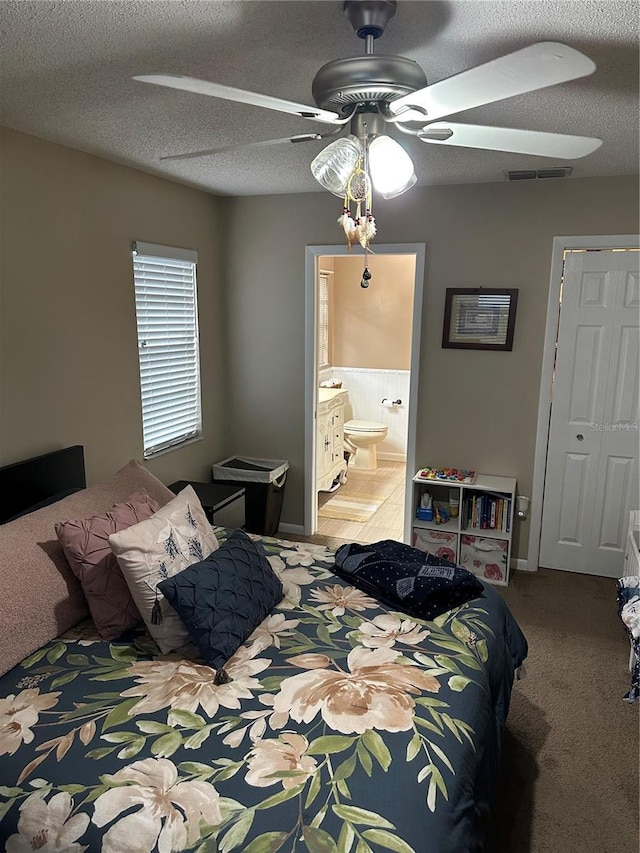 2158 Clayton Ave, Spring Hill, FL 34609 - bedroom featuring carpet, ensuite bath, ceiling fan, and a textured ceiling