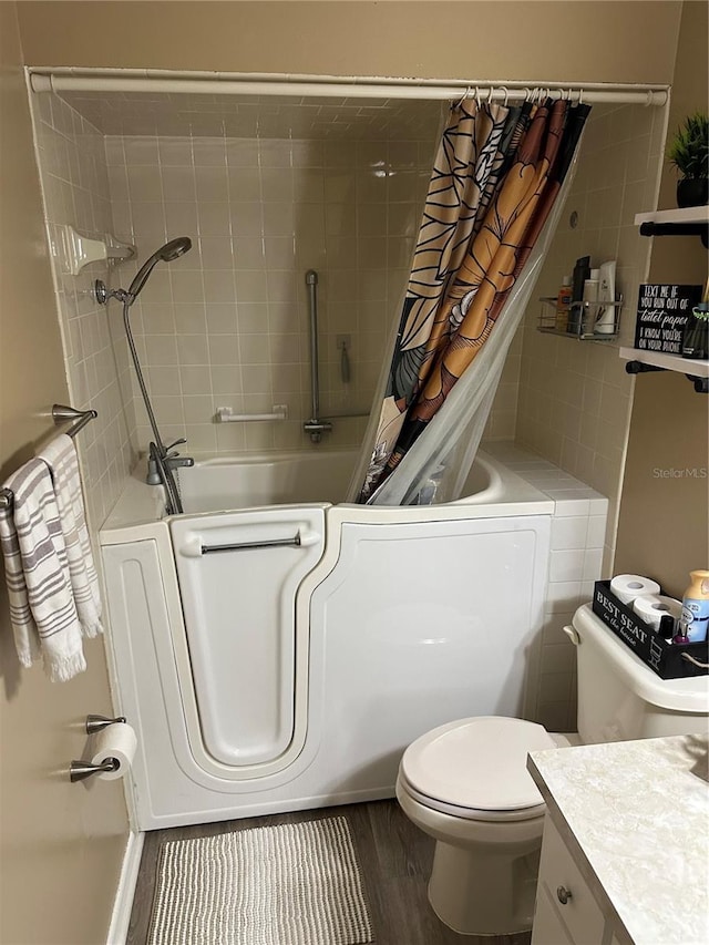2158 Clayton Ave, Spring Hill, FL 34609 - full bathroom with toilet, wood finished floors, vanity, and shower / tub combo with curtain