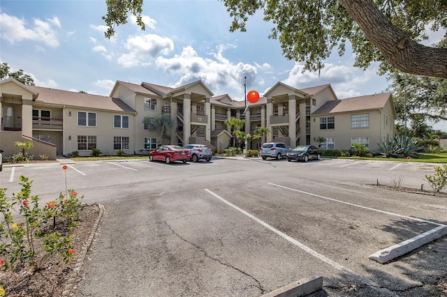 uncovered parking lot featuring a residential view