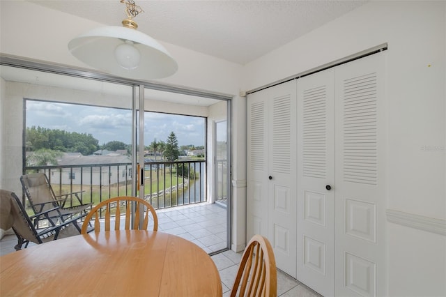 dining room featuring light tile patterned flooring and healthy amount of natural light