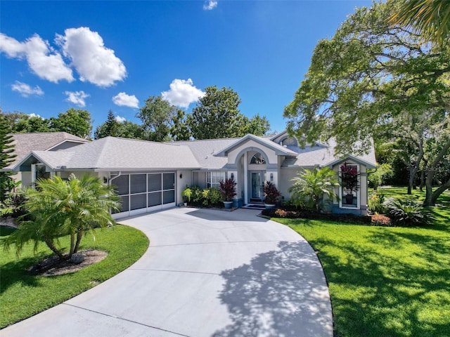 13627 Glaze Brook Dr, Hudson, FL 34667 - single story home with a front lawn, curved driveway, and stucco siding