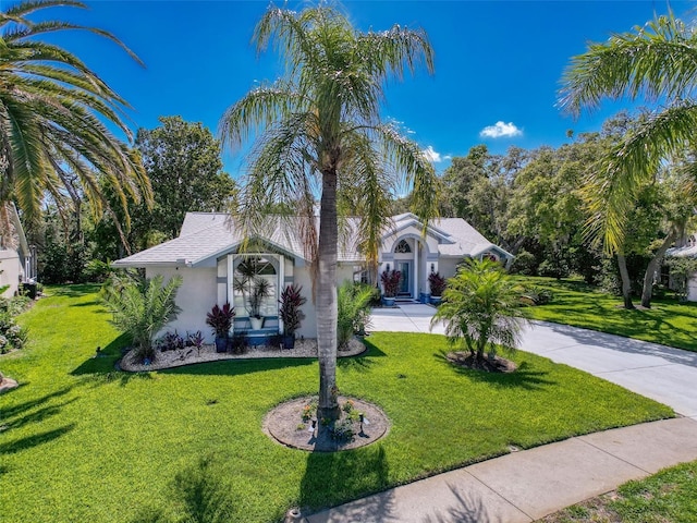 13627 Glaze Brook Dr, Hudson, FL 34667 - view of front of home featuring stucco siding, a front yard, and concrete driveway