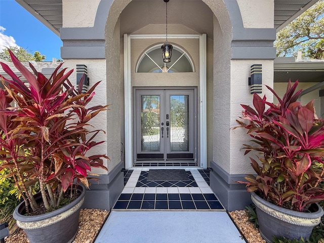 13627 Glaze Brook Dr, Hudson, FL 34667 - property entrance featuring french doors and stucco siding