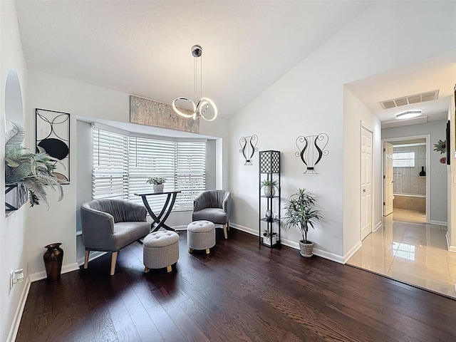 13627 Glaze Brook Dr, Hudson, FL 34667 - sitting room featuring wood finished floors, baseboards, and vaulted ceiling