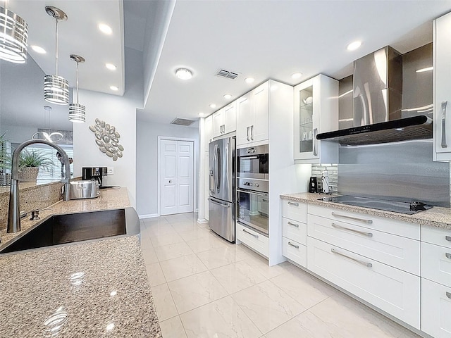 13627 Glaze Brook Dr, Hudson, FL 34667 - kitchen with wall chimney exhaust hood, stainless steel appliances, a sink, light stone counters, and recessed lighting