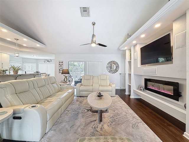 13627 Glaze Brook Dr, Hudson, FL 34667 - living area featuring recessed lighting, dark wood finished floors, ceiling fan, a glass covered fireplace, and baseboards