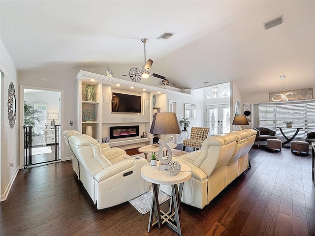 13627 Glaze Brook Dr, Hudson, FL 34667 - living area with vaulted ceiling, dark wood finished floors, a ceiling fan, a glass covered fireplace, and french doors
