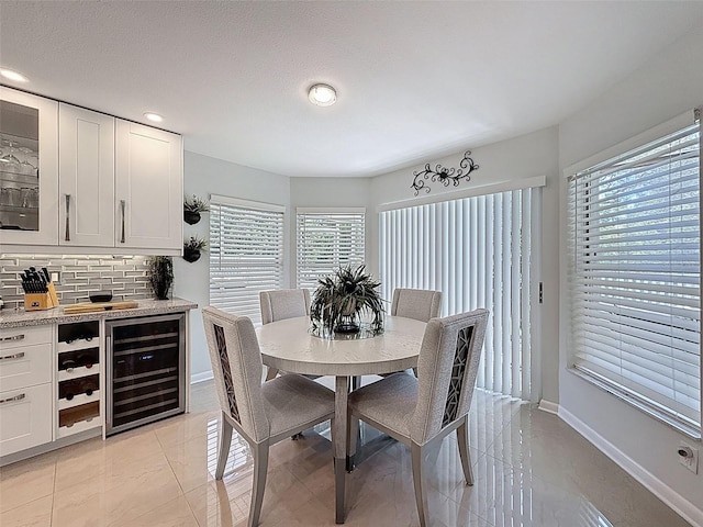 13627 Glaze Brook Dr, Hudson, FL 34667 - dining area with wine cooler, baseboards, and recessed lighting