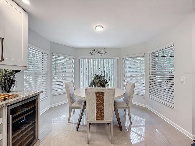 13627 Glaze Brook Dr, Hudson, FL 34667 - dining room featuring wine cooler and baseboards