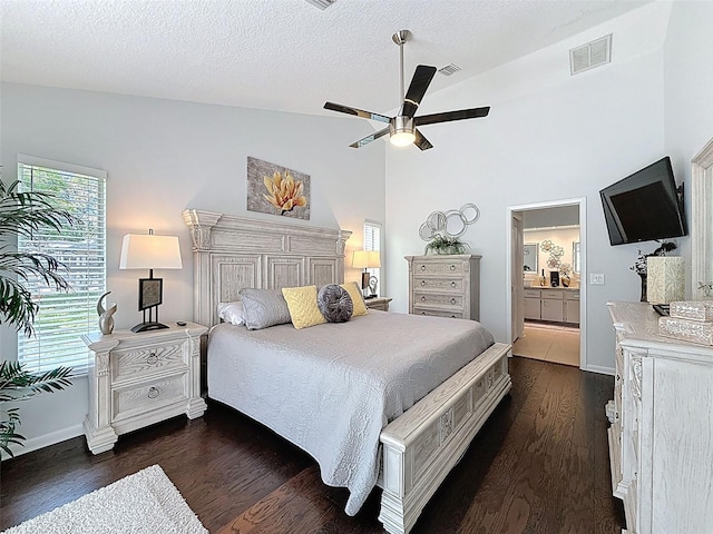 13627 Glaze Brook Dr, Hudson, FL 34667 - bedroom featuring lofted ceiling, dark wood-style floors, baseboards, a textured ceiling, and ensuite bathroom