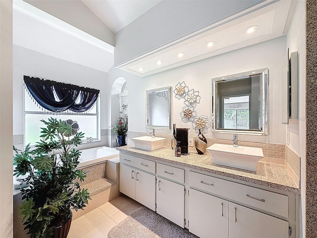 13627 Glaze Brook Dr, Hudson, FL 34667 - bathroom featuring tile patterned flooring, a garden tub, double vanity, lofted ceiling, and recessed lighting