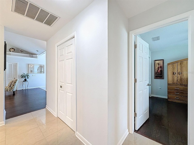 13627 Glaze Brook Dr, Hudson, FL 34667 - hall featuring marble look tiles, baseboards, and lofted ceiling