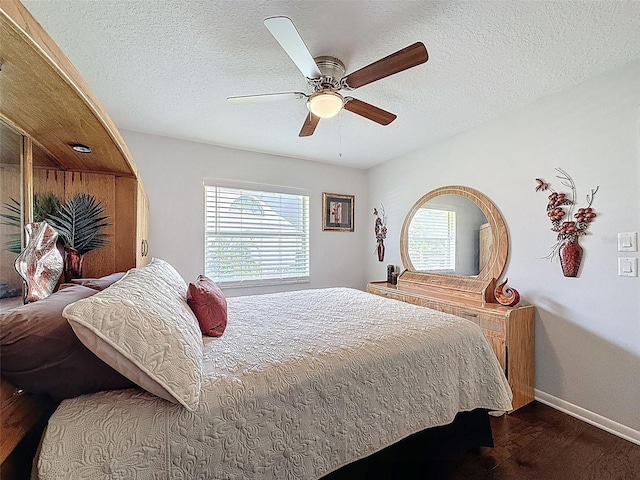 13627 Glaze Brook Dr, Hudson, FL 34667 - bedroom with dark wood-style flooring, multiple windows, baseboards, a textured ceiling, and ceiling fan