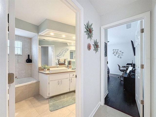 13627 Glaze Brook Dr, Hudson, FL 34667 - full bathroom featuring tiled shower / bath combo, vanity, and baseboards