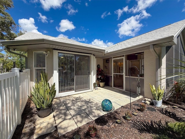 13627 Glaze Brook Dr, Hudson, FL 34667 - back of property featuring stucco siding, a patio, and a shingled roof