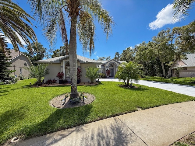 13627 Glaze Brook Dr, Hudson, FL 34667 - view of front of house featuring stucco siding and a front yard
