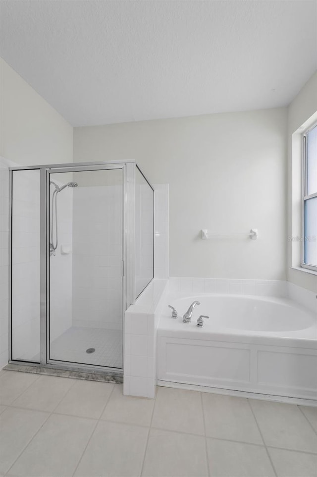 10344 Tecoma Dr, Trinity, FL 34655 - full bathroom featuring a bath, a stall shower, and tile patterned flooring