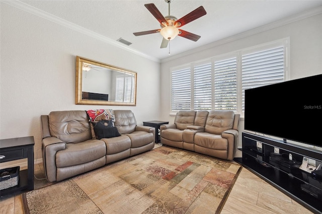 living room featuring a ceiling fan, crown molding, and baseboards