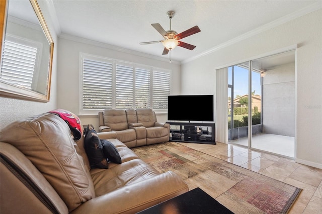 living area with ornamental molding, a ceiling fan, marble look tile flooring, and baseboards