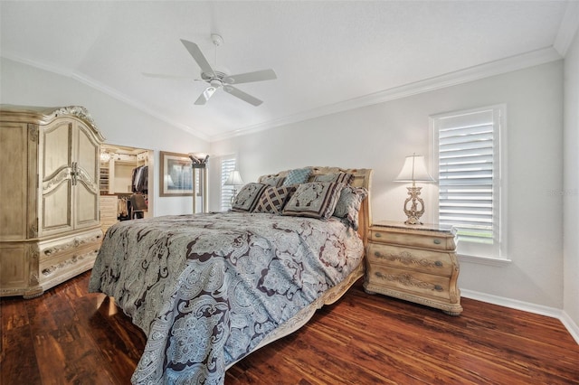 bedroom with dark wood-style flooring, a walk in closet, lofted ceiling, crown molding, and baseboards