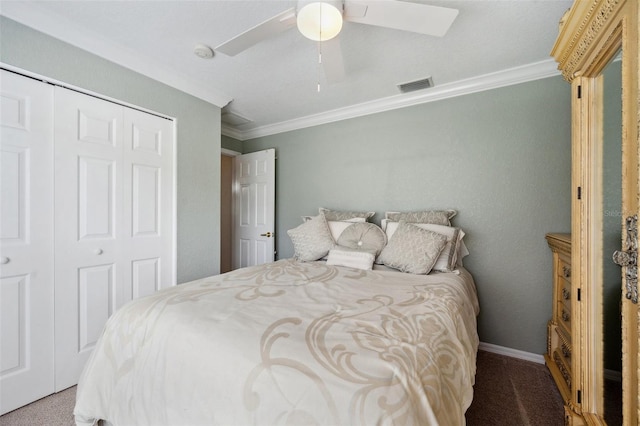 carpeted bedroom with crown molding, a closet, a ceiling fan, and baseboards