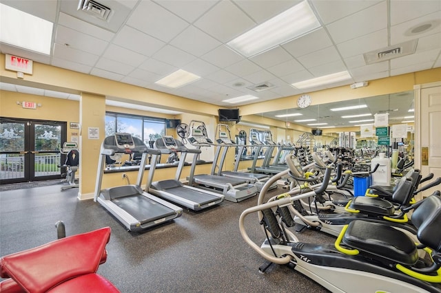 workout area featuring a drop ceiling and french doors