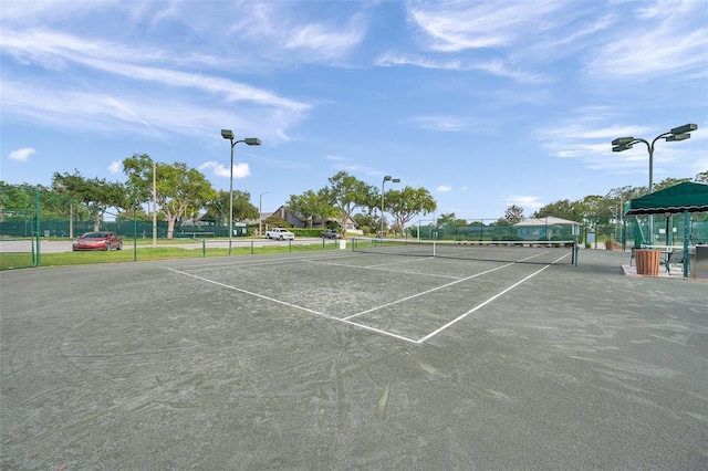 view of tennis court with fence