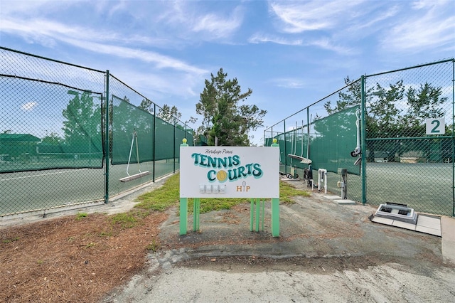 view of tennis court with fence