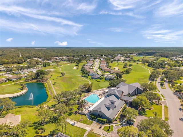aerial perspective of suburban area with a nearby body of water and a golf course
