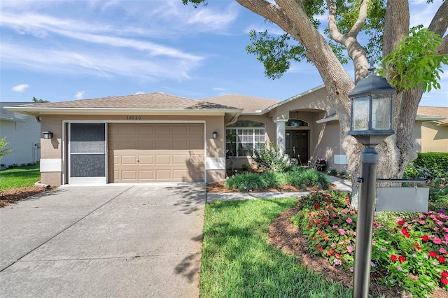 view of front of house featuring stucco siding, driveway, and a garage