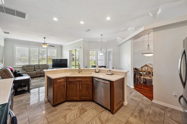 18520 Hidden Pines Way, Hudson, FL 34667 - kitchen featuring stainless steel appliances, a sink, ornamental molding, healthy amount of natural light, and open floor plan